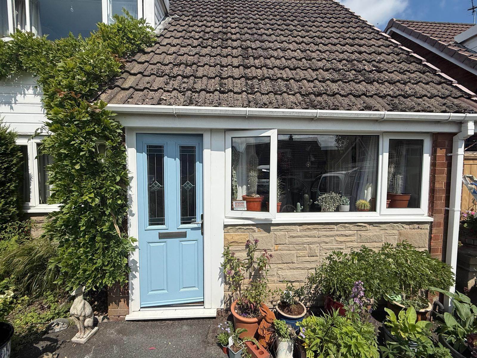 Stone cottage front door sprayed sky blue