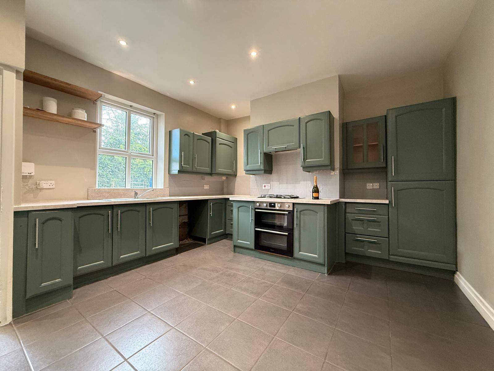 Kitchen with cabinet doors sprayed sage green