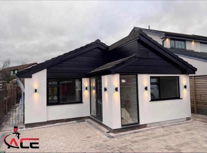 The same bungalow with the roofline, window frames and doors sprayed satin black